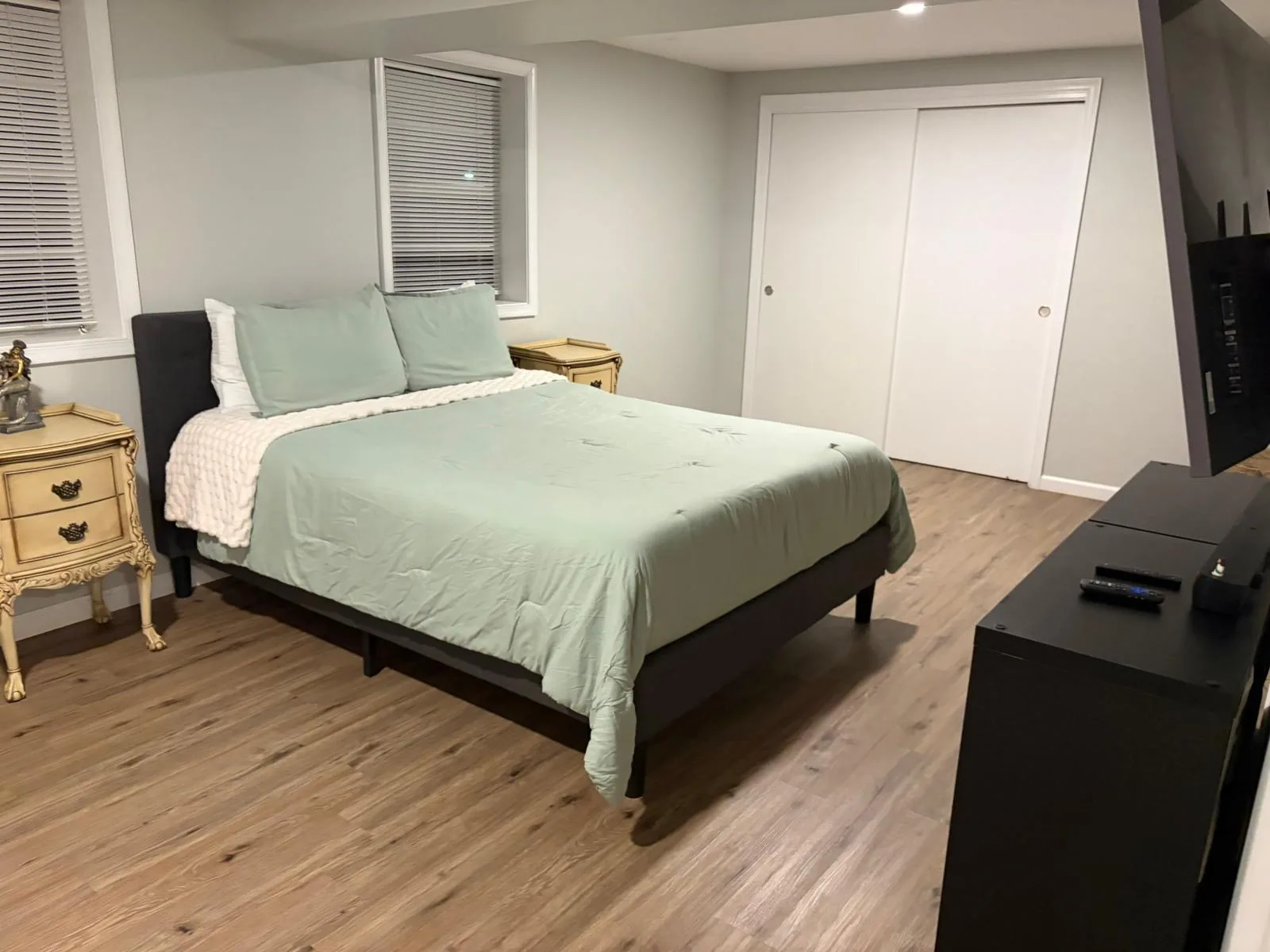Basement bedroom with mint bedding