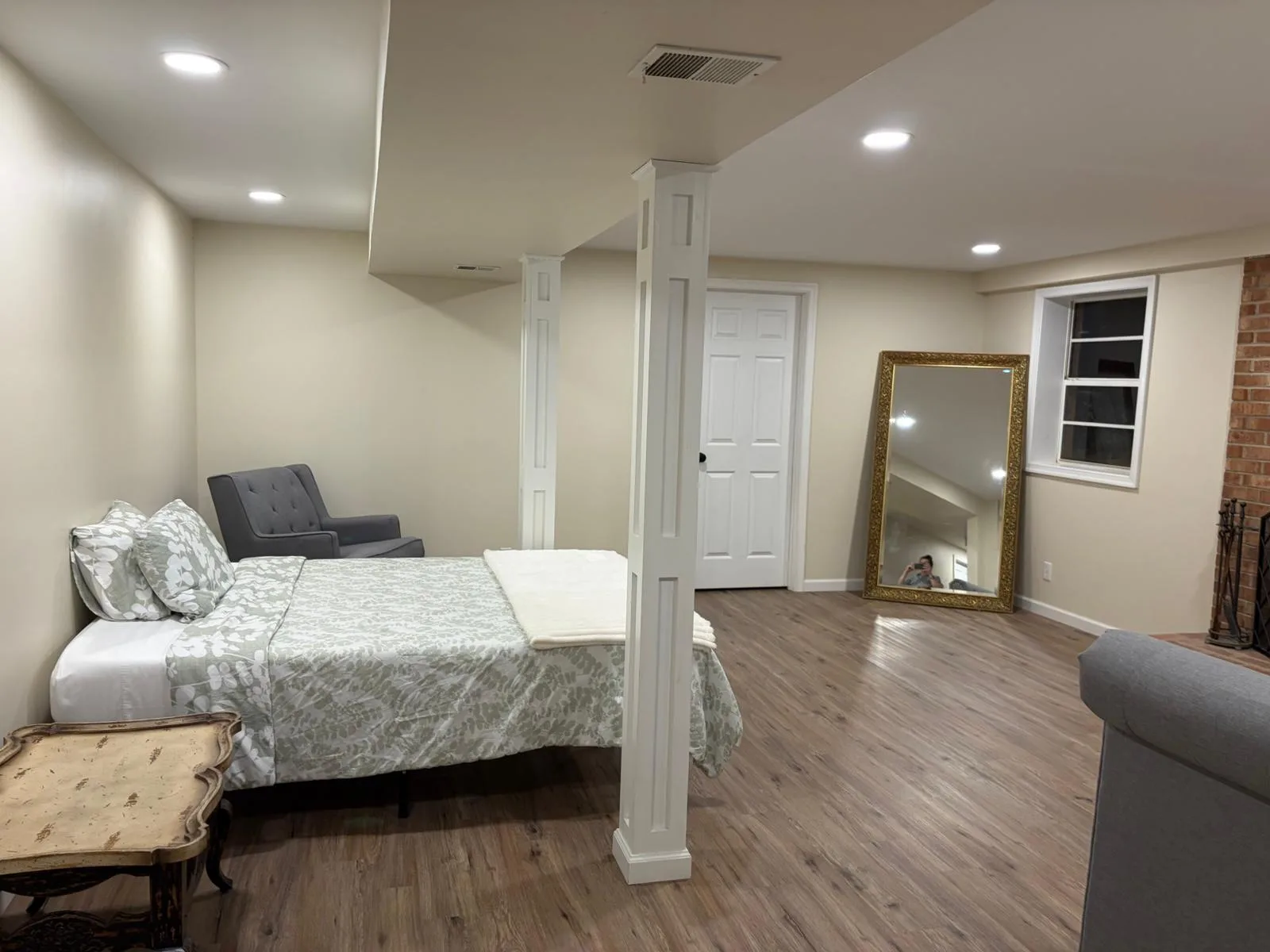 Basement open area with bed and mirror