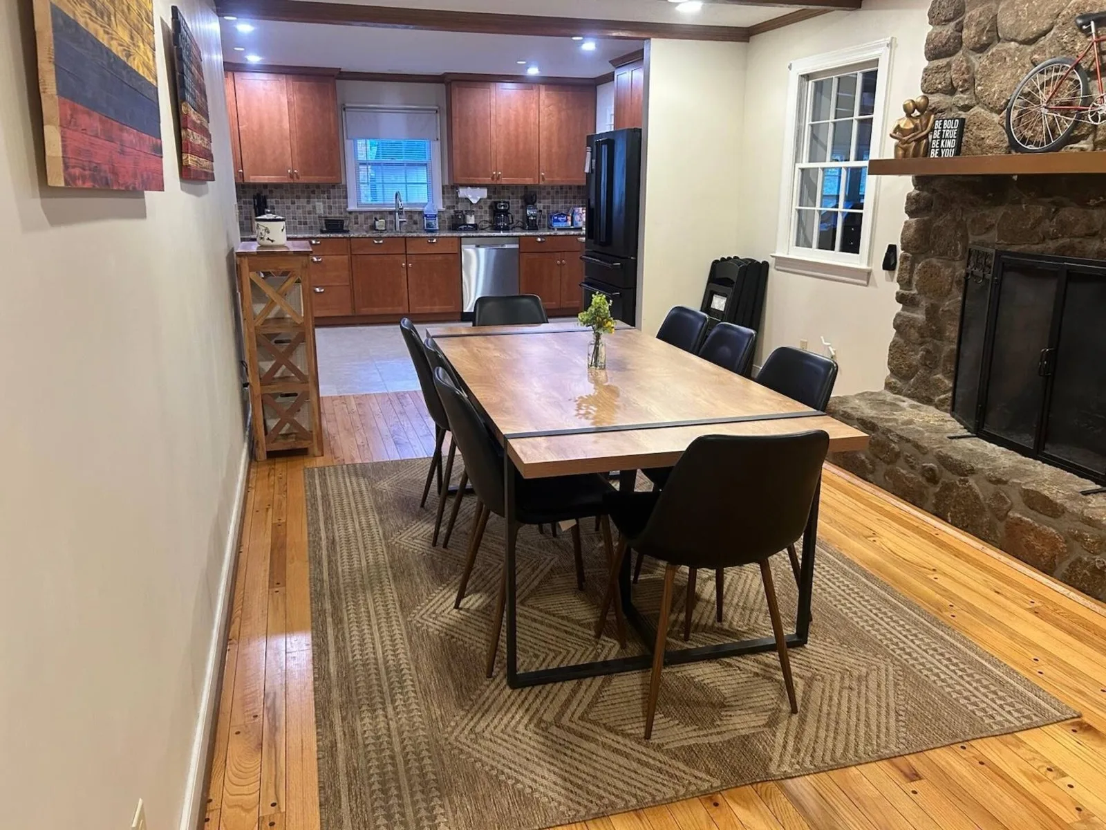 Dining room and kitchen with stone fireplace